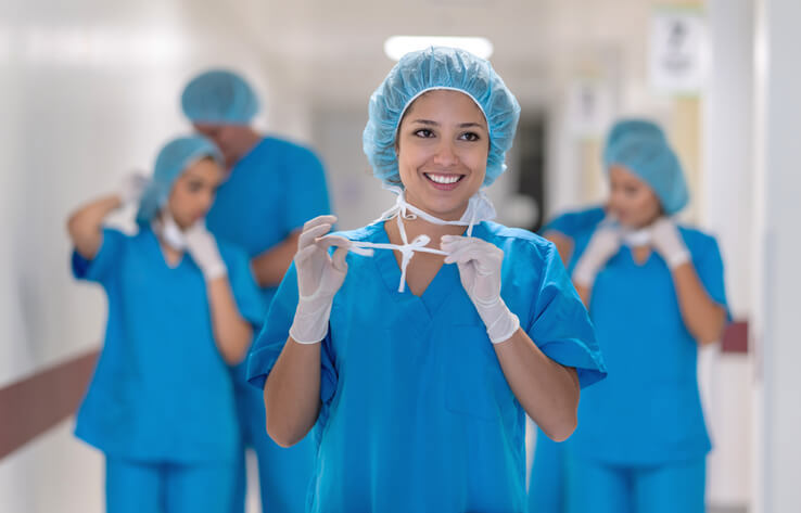 nurse getting out of operating room and removing mask